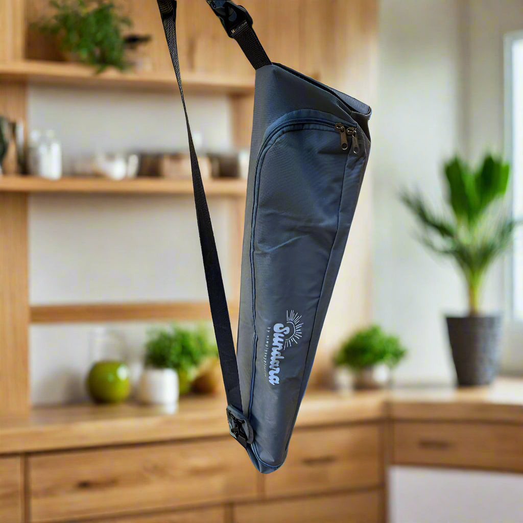 Blue sling bag on a wooden surface with a bottle and container in the background