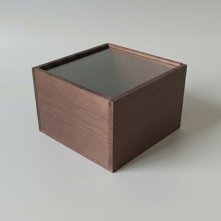 Wooden box with a glass lid on a white surface