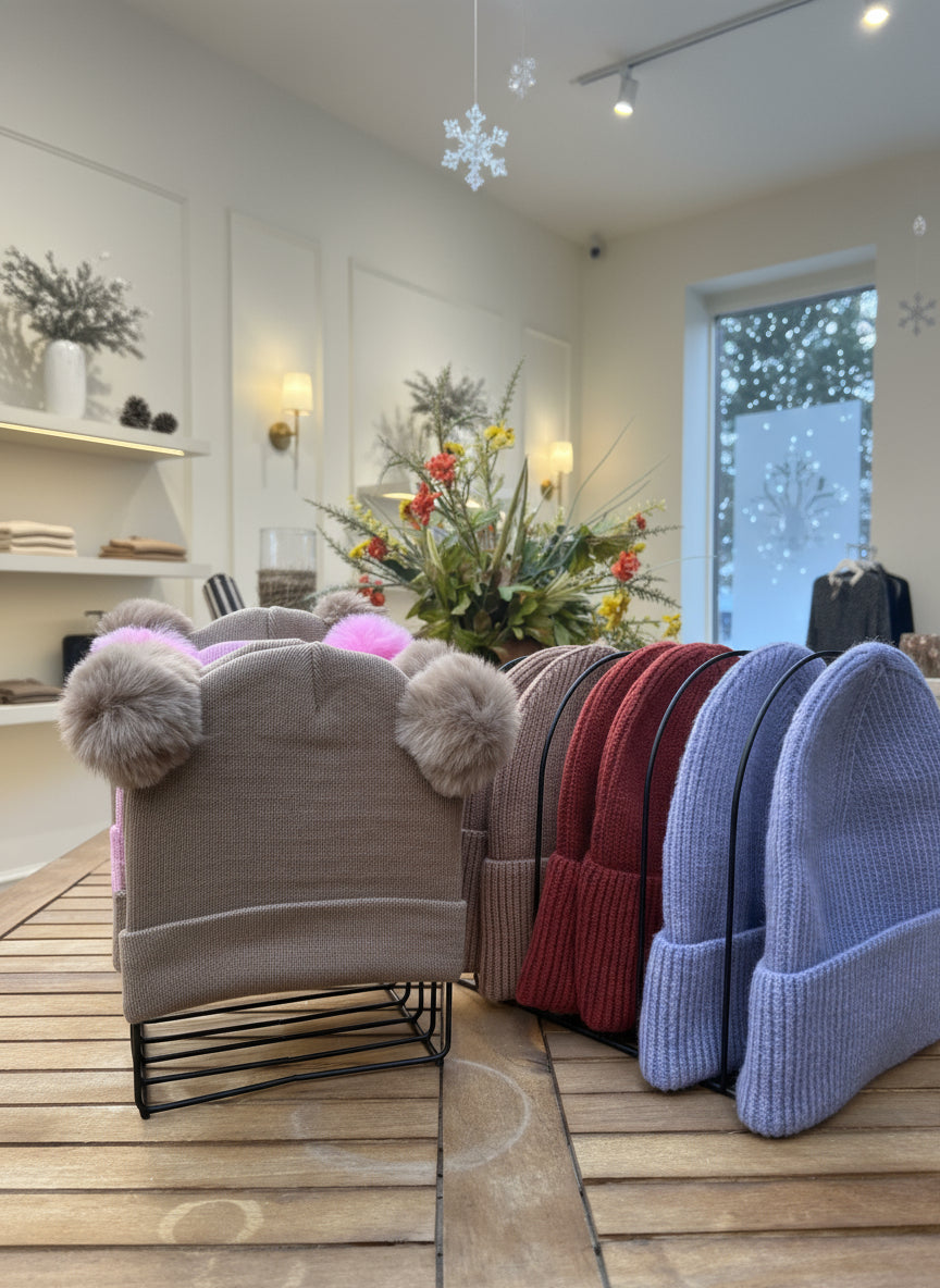 Stack of folded clothes on a wooden surface with a blurred outdoor background