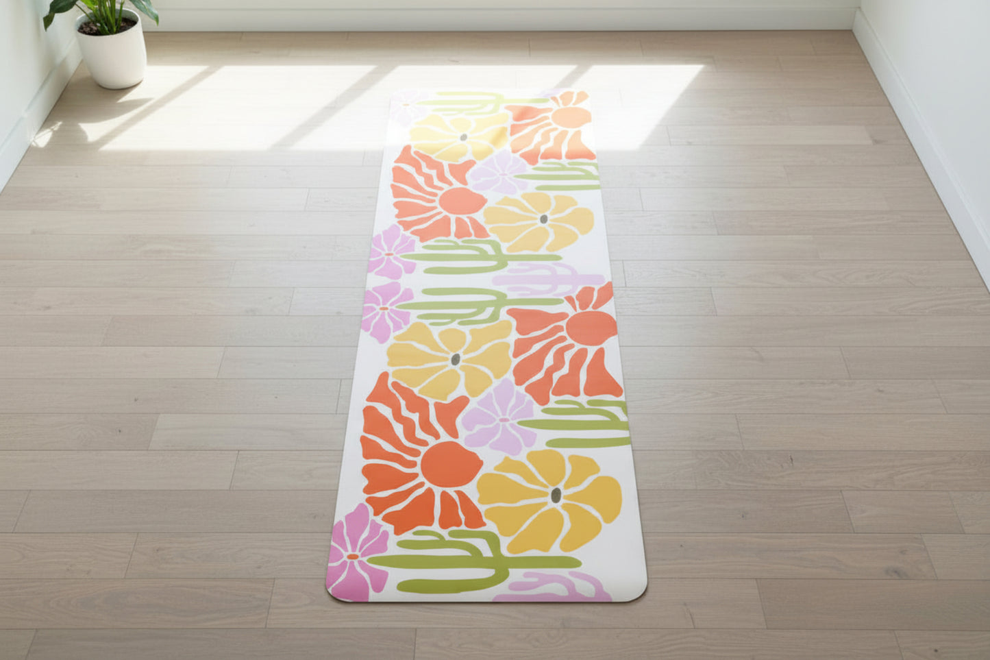 Floral patterned mat on a wooden floor, brightly lid yoga studio vibes